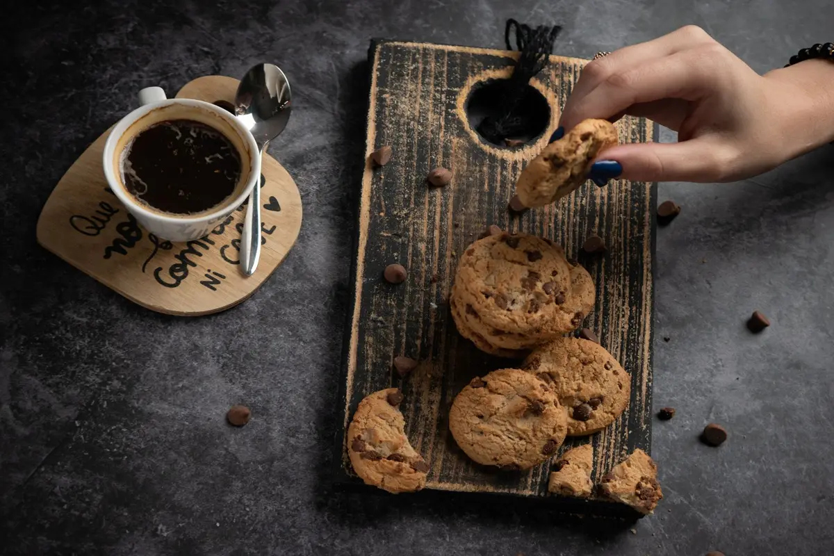 Delicious chocolate chip cookies paired with a freshly brewed cup of espresso for a perfect treat.