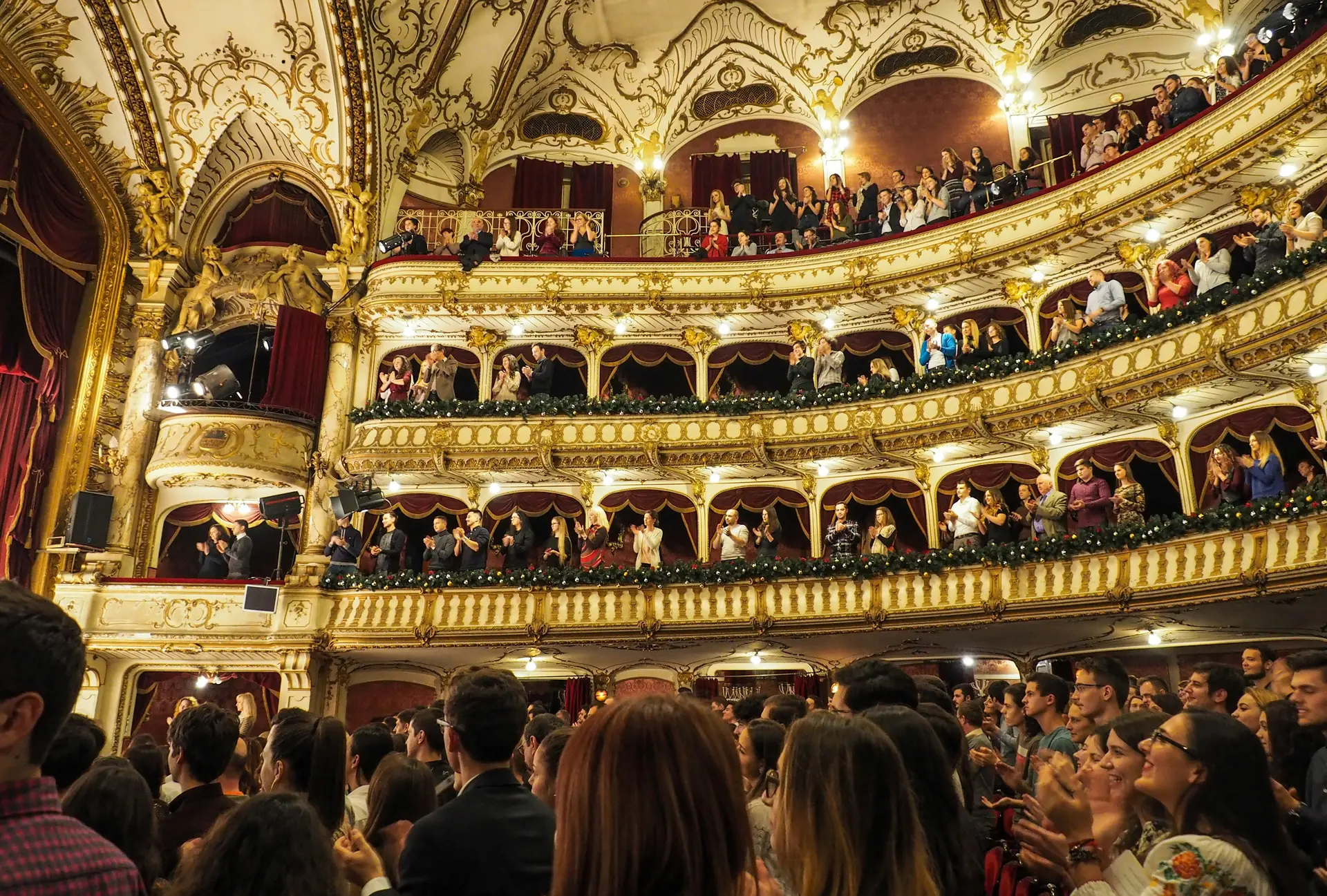Lot's of people in a theater enjoying a play.