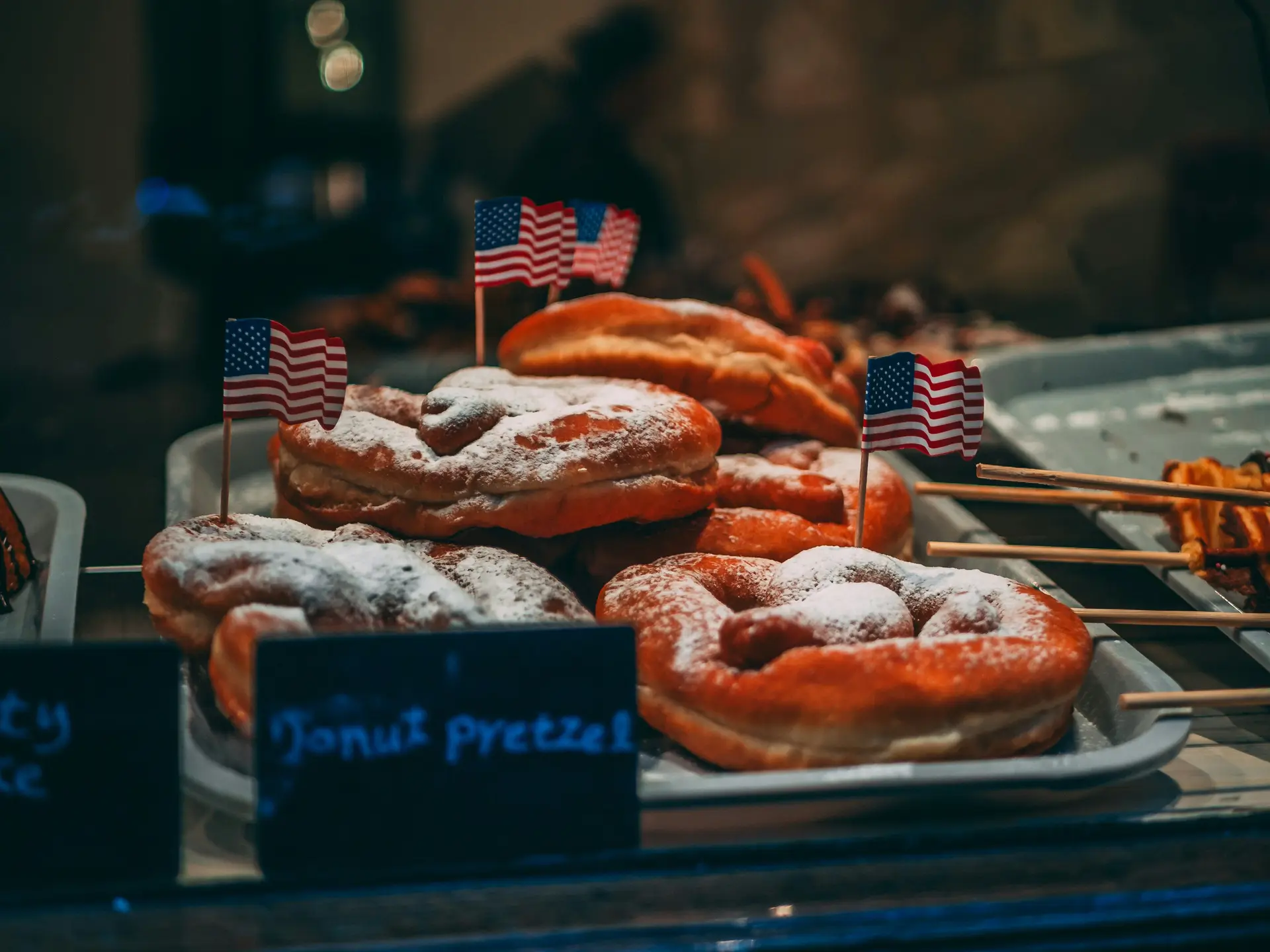 Close up photo of a bunch of pretzels that has tiny USA flags placed on them.