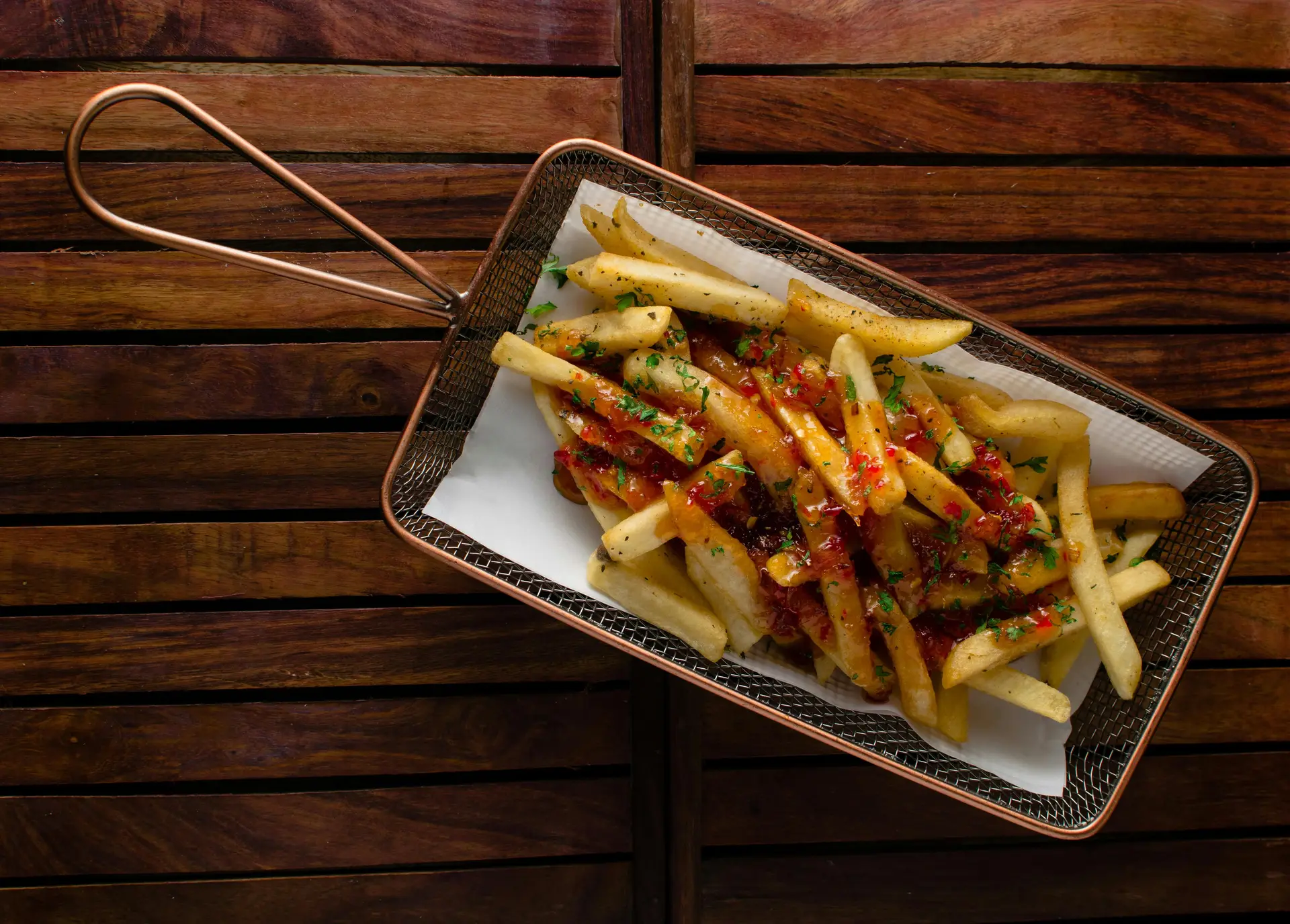 Crispy French fries served with condiments on it to celebrate National French Fry Day.