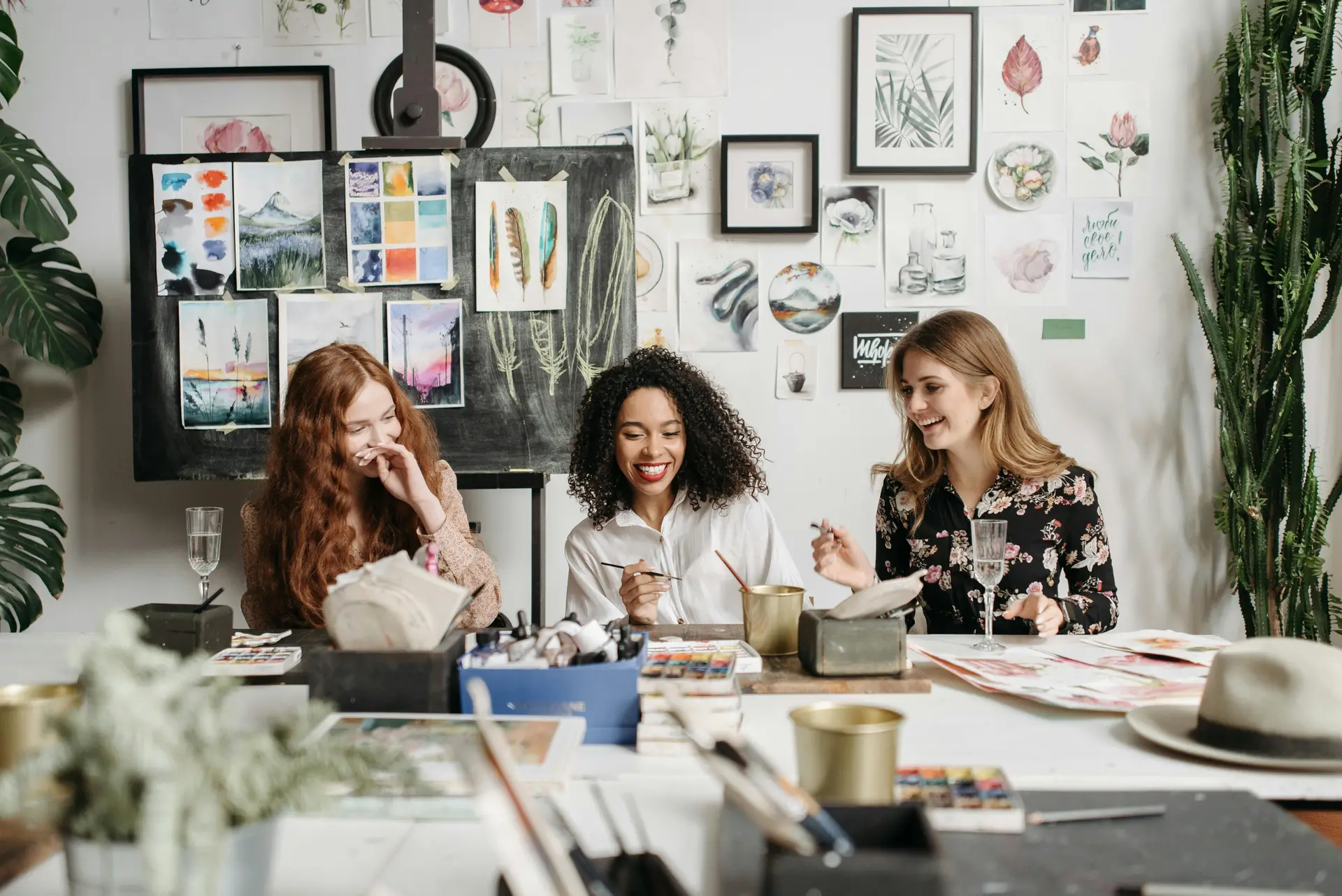 3 women in a painting class, drawing and having fun.