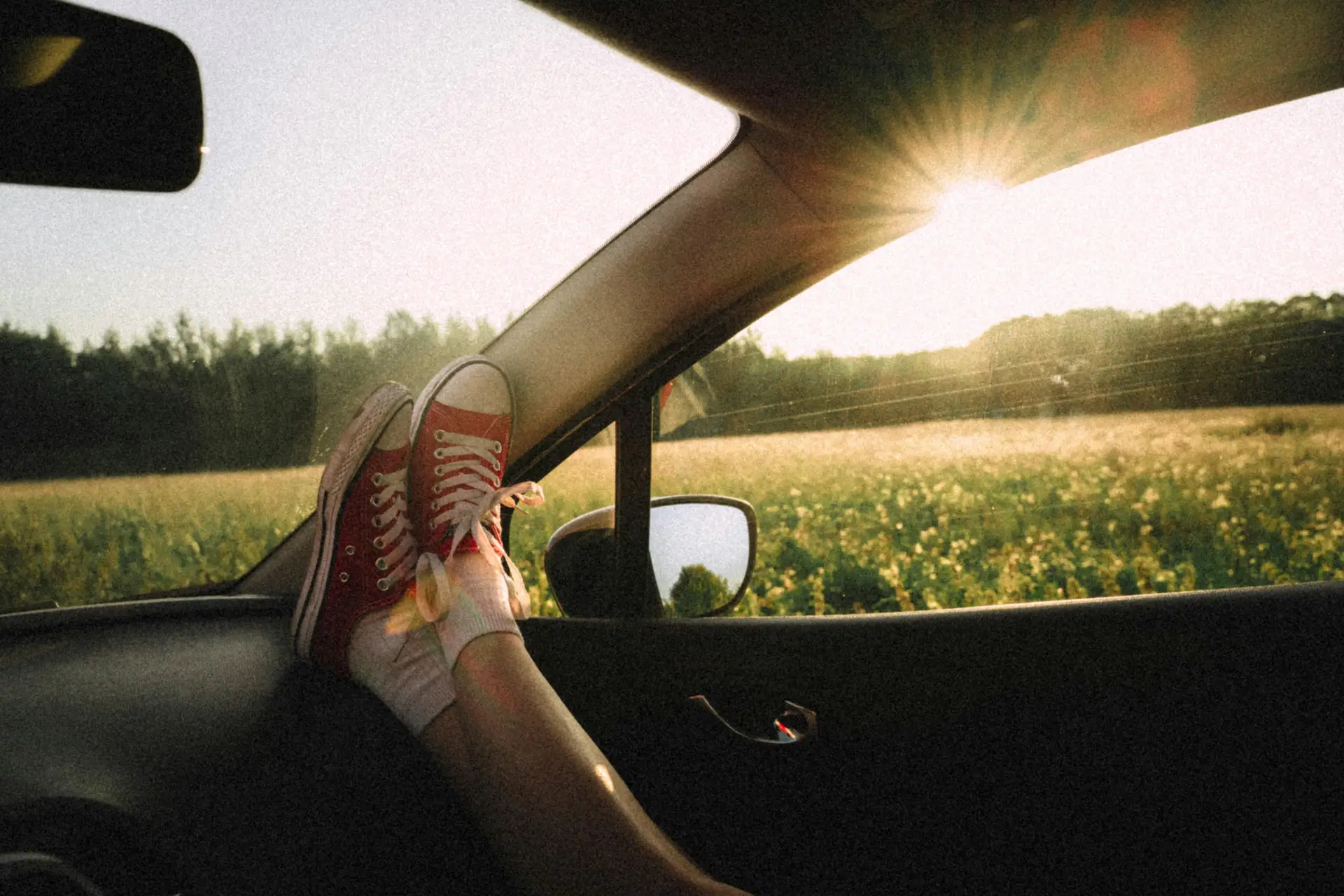 Person In A Vehicle With Legs Stretched On the Dashboard.