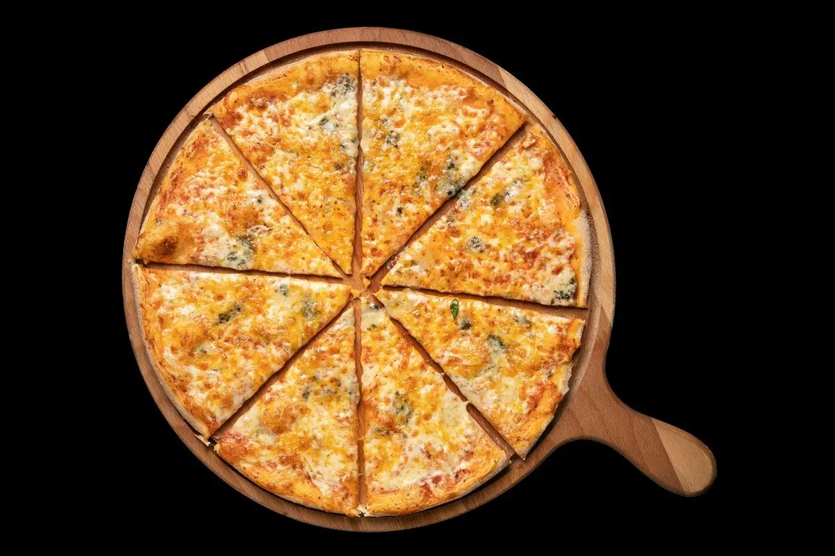 A cheese pizza placed in pizza paddle on a black background.