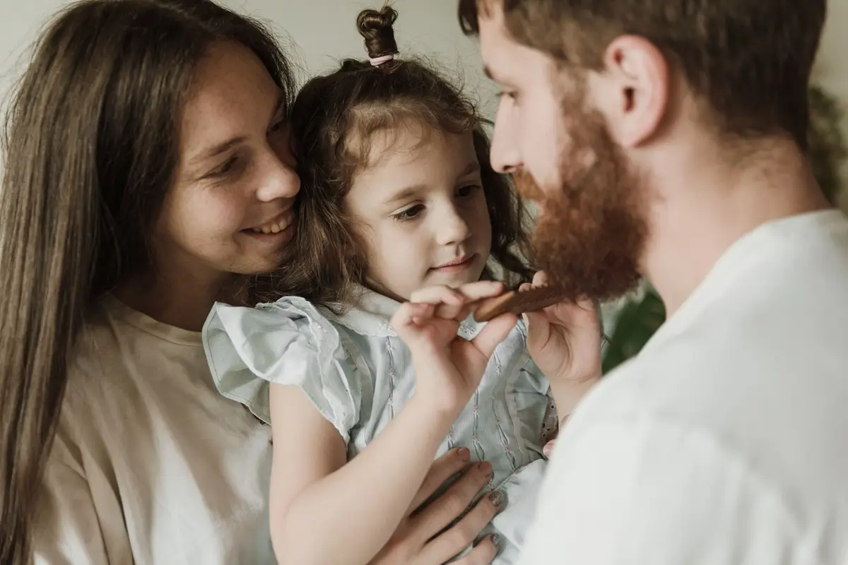 Joyful family moment with parents and child indoors. Love and bonding.