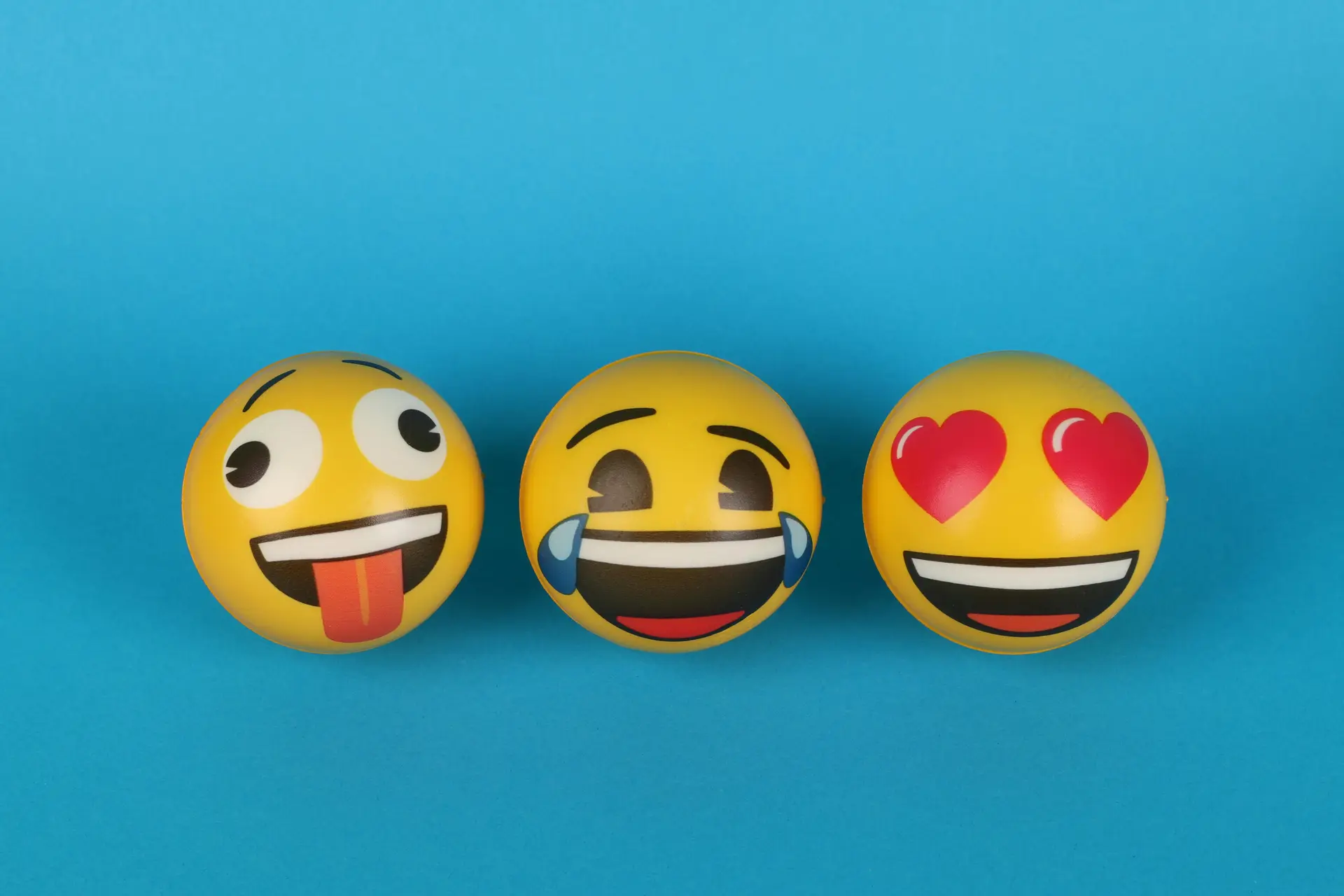 Smileys with three different expressions on blue background.