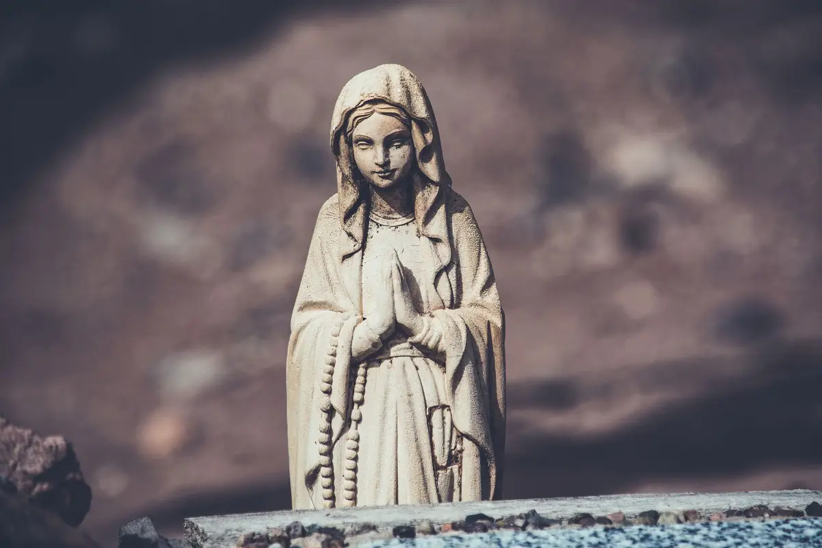 A detailed sculpture of a prayerful woman, symbolizing spirituality and peace.
