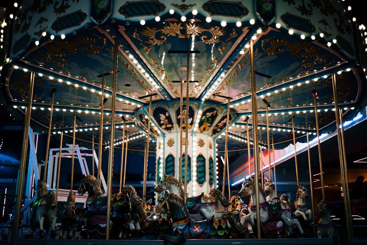 Colorful carousel at night in a mall, evoking fun and nostalgia.