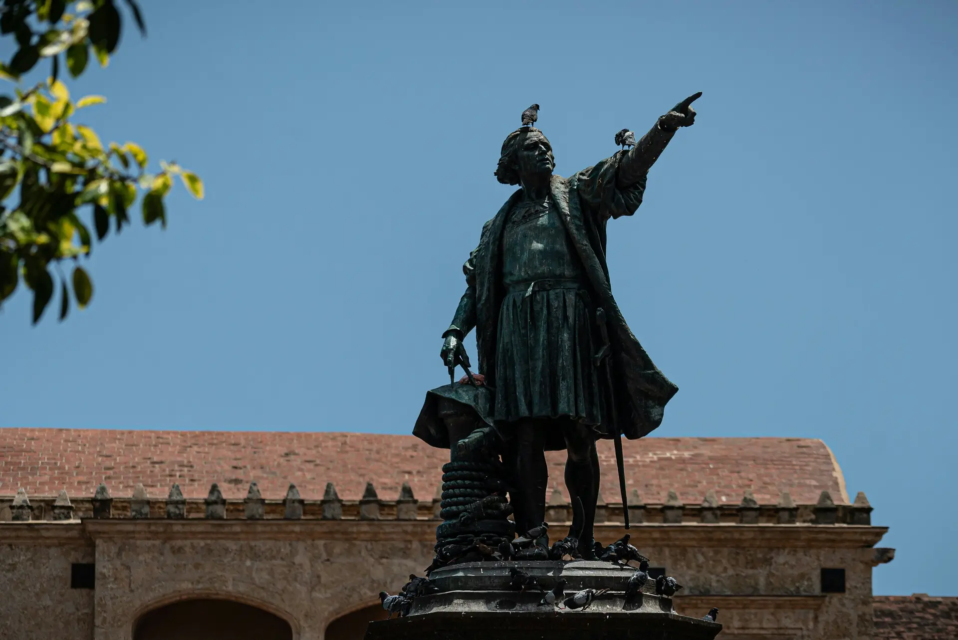 Statue of Christopher Columbus points forever to his next conquest in the Zona Colonial in Santo Domingo, Dominican Republic.