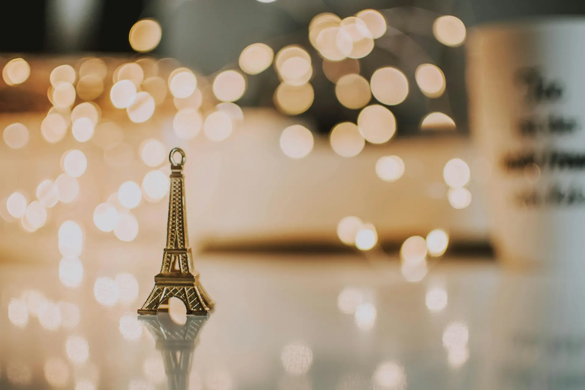 Eiffel Tower replica with bokeh lights in the background.