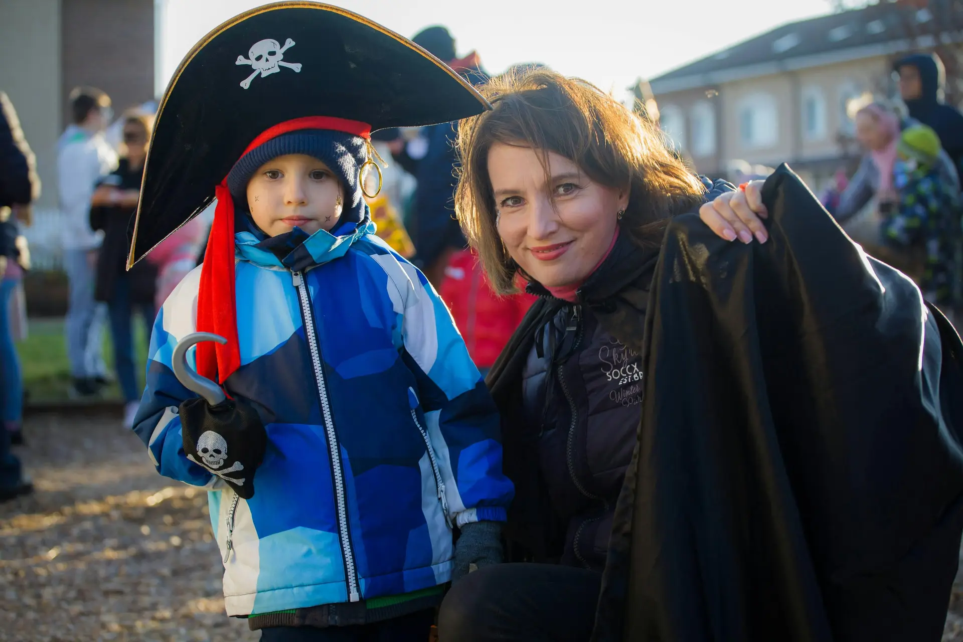Kid wearing Pirate costume along with a woman, possibly their mother.