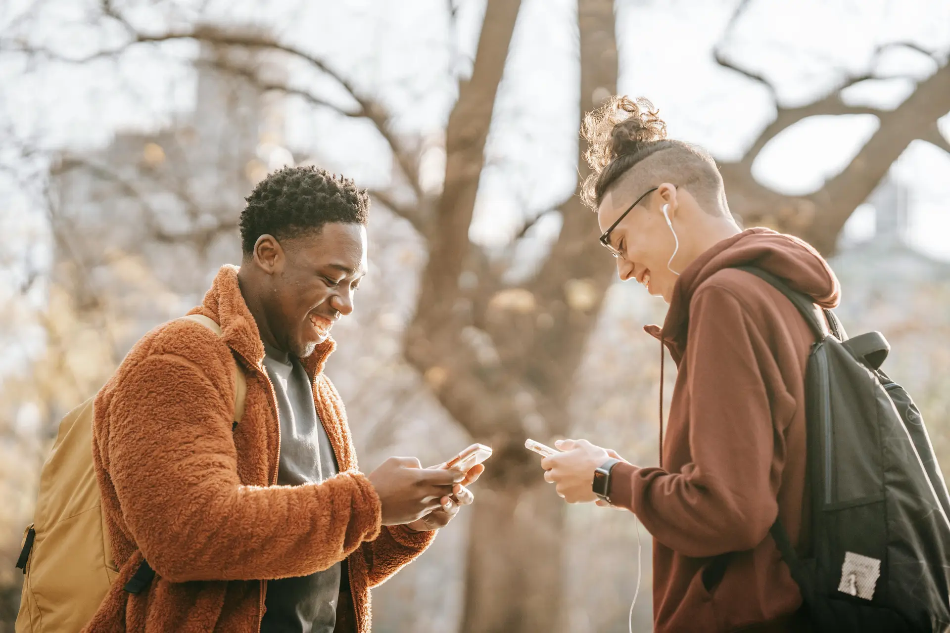 Two person using their phone probably to share memes.
