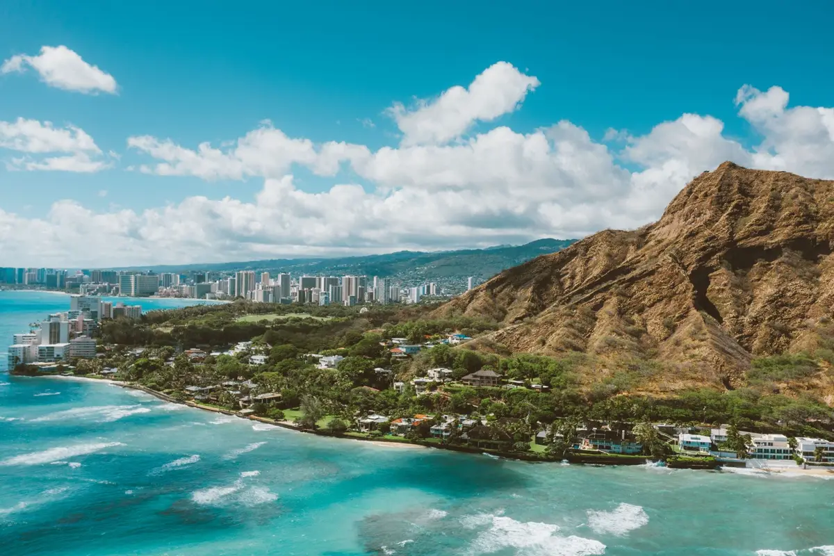 Stunning aerial image of Diamond Head crater and vibrant coastline in Honolulu, Hawaii.