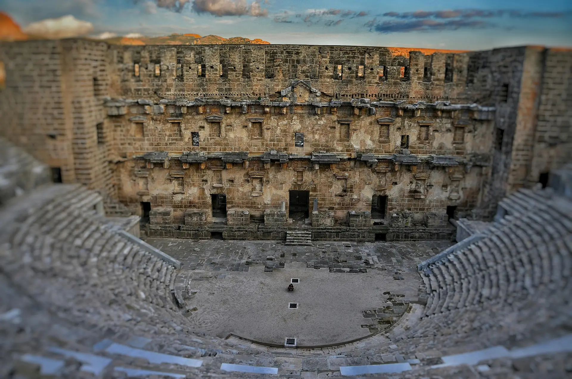 A tilt-shift photo of an anicent amphitheater.