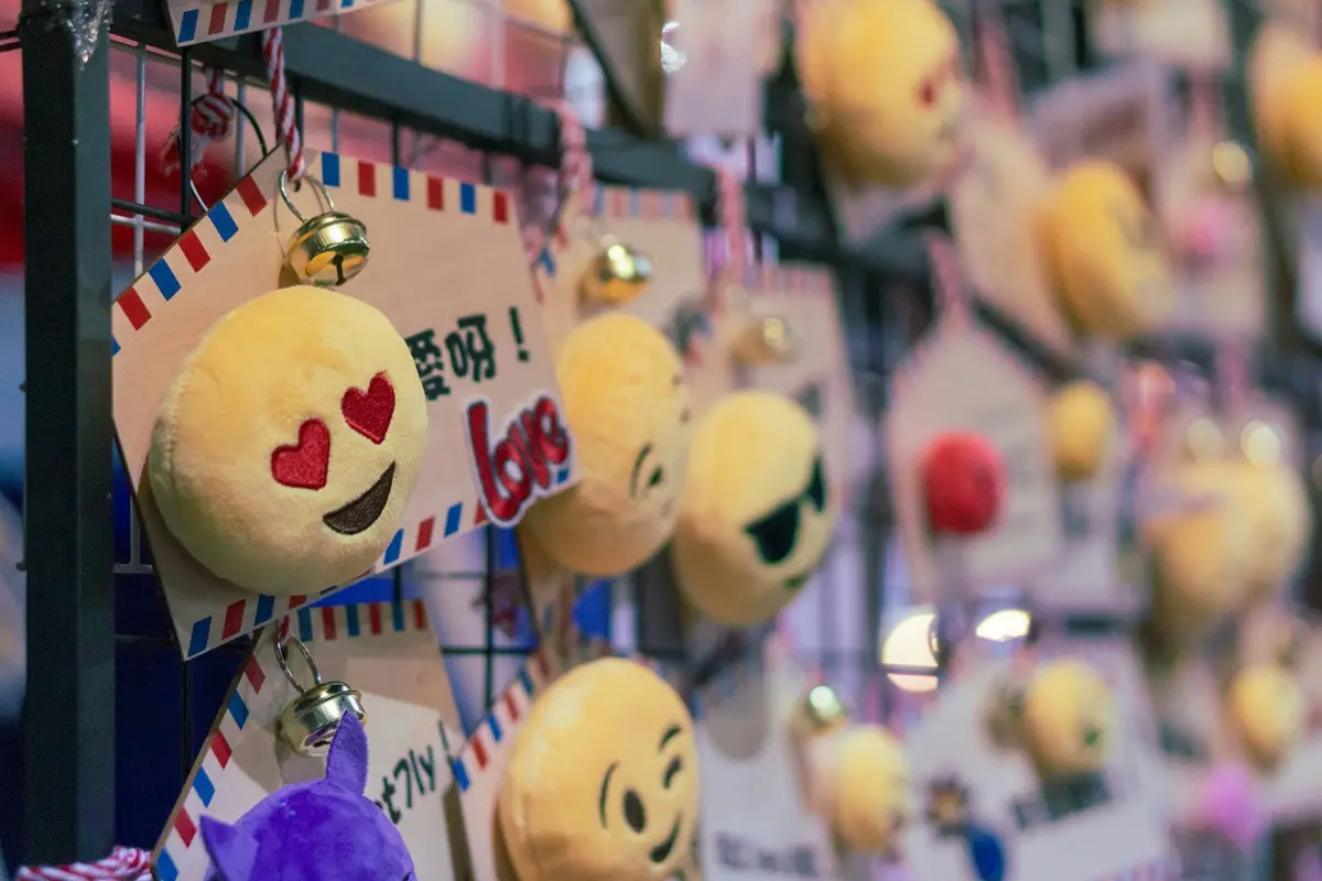 Heart eye emoji keychain displayed in a shop.