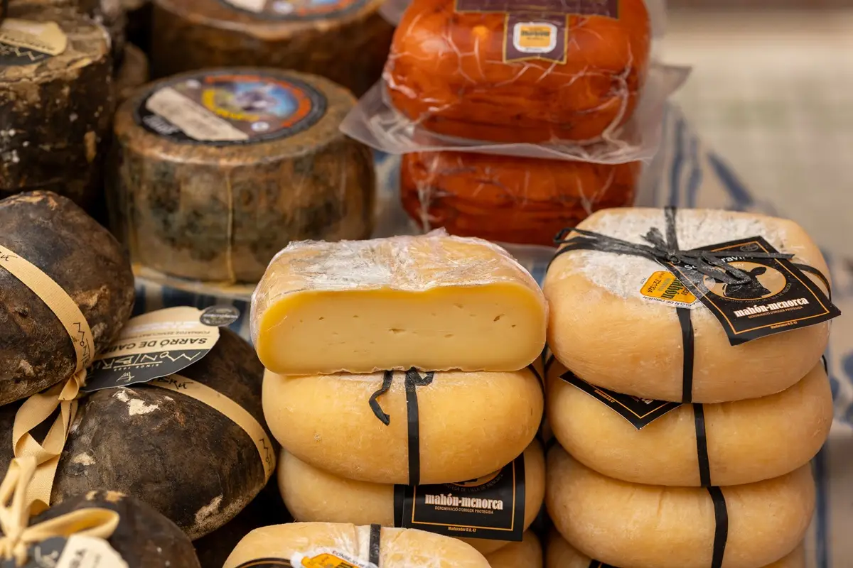 Assorted traditional Spanish cheeses displayed at a market stall.