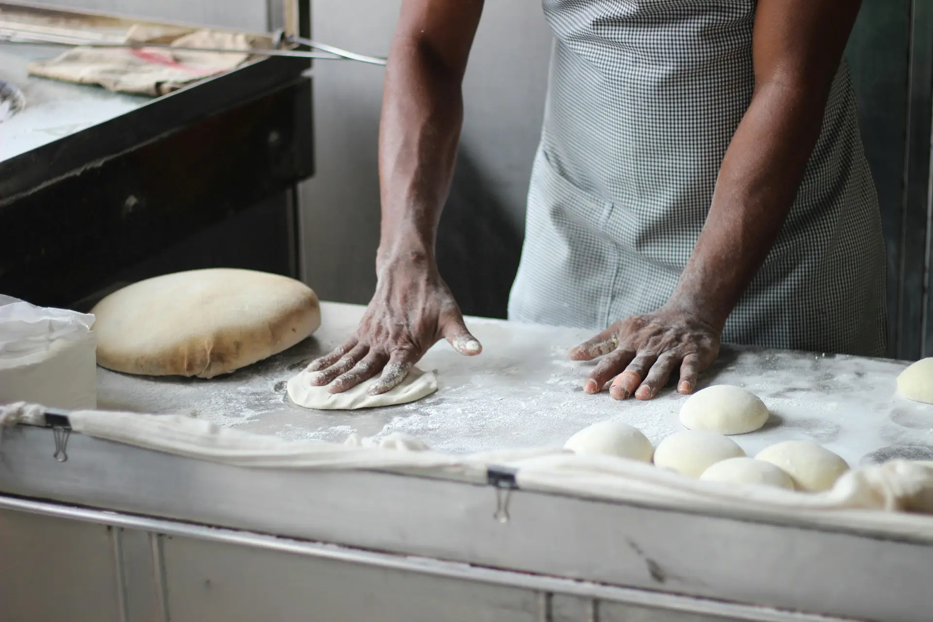 A baker preparing dough to make baked foods.