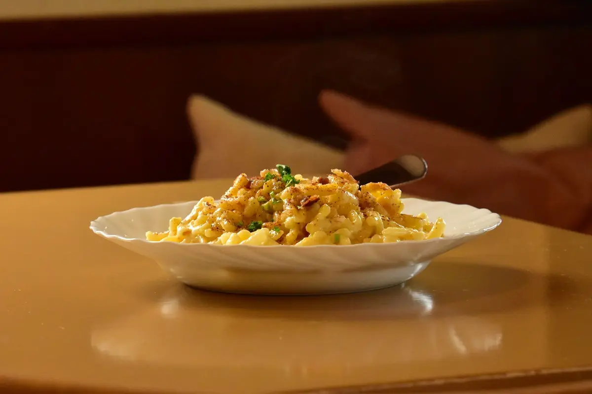 Gourmet mac and cheese on a table, perfect for food blogs.