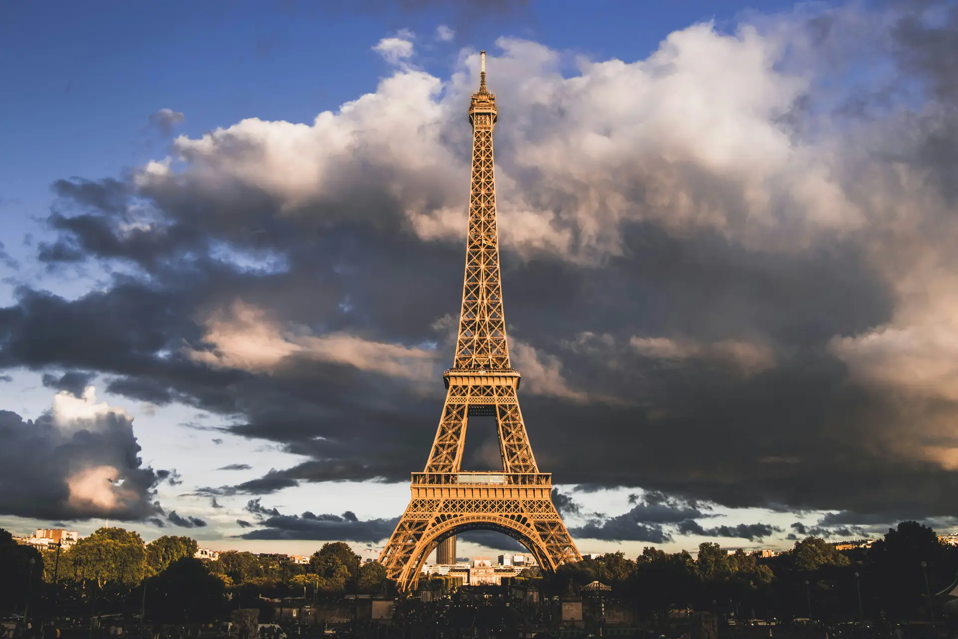 Eiffel tower with cloudy sky in the background.