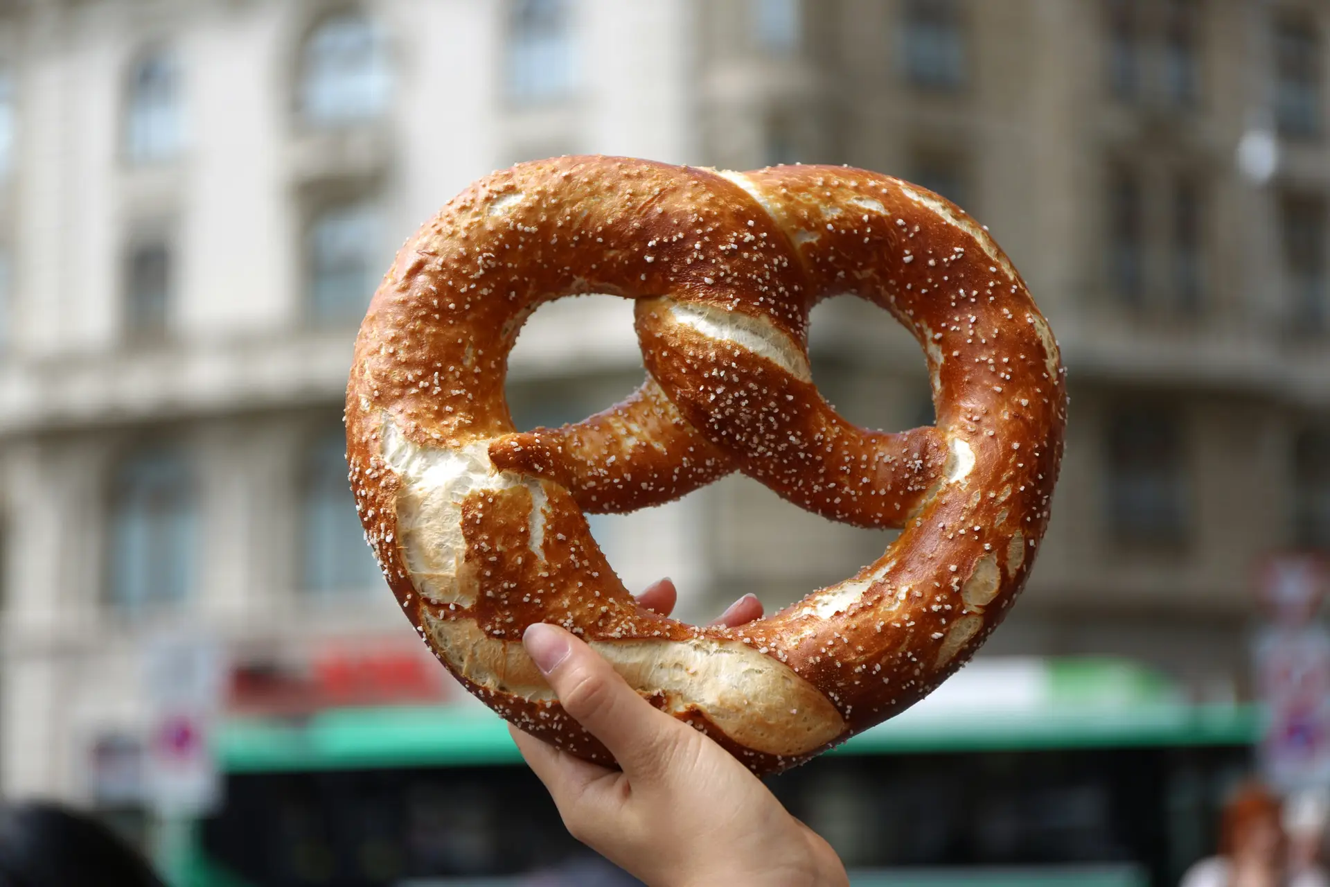 Person holding a big pretzel.