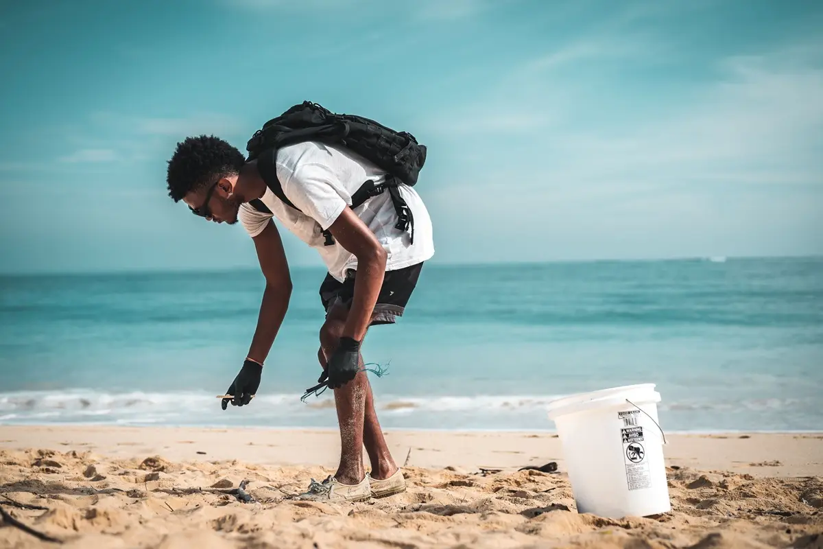 A person cleaning up the beach.