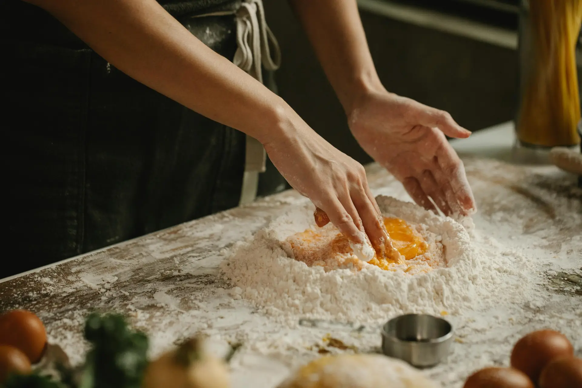 A person mixing yolk with flour for making pastry.