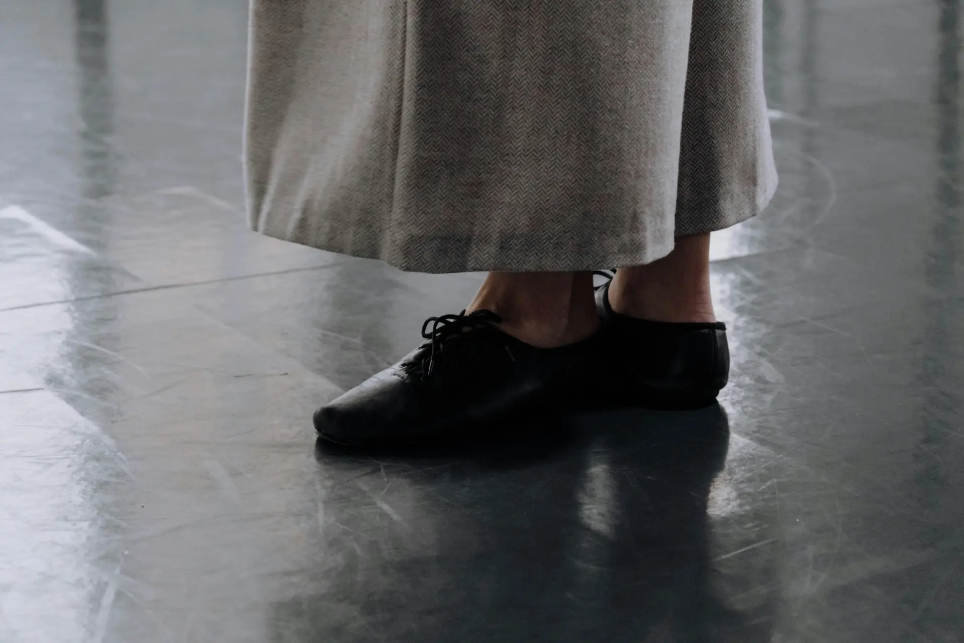 Woman wearing tap dancing shoe.