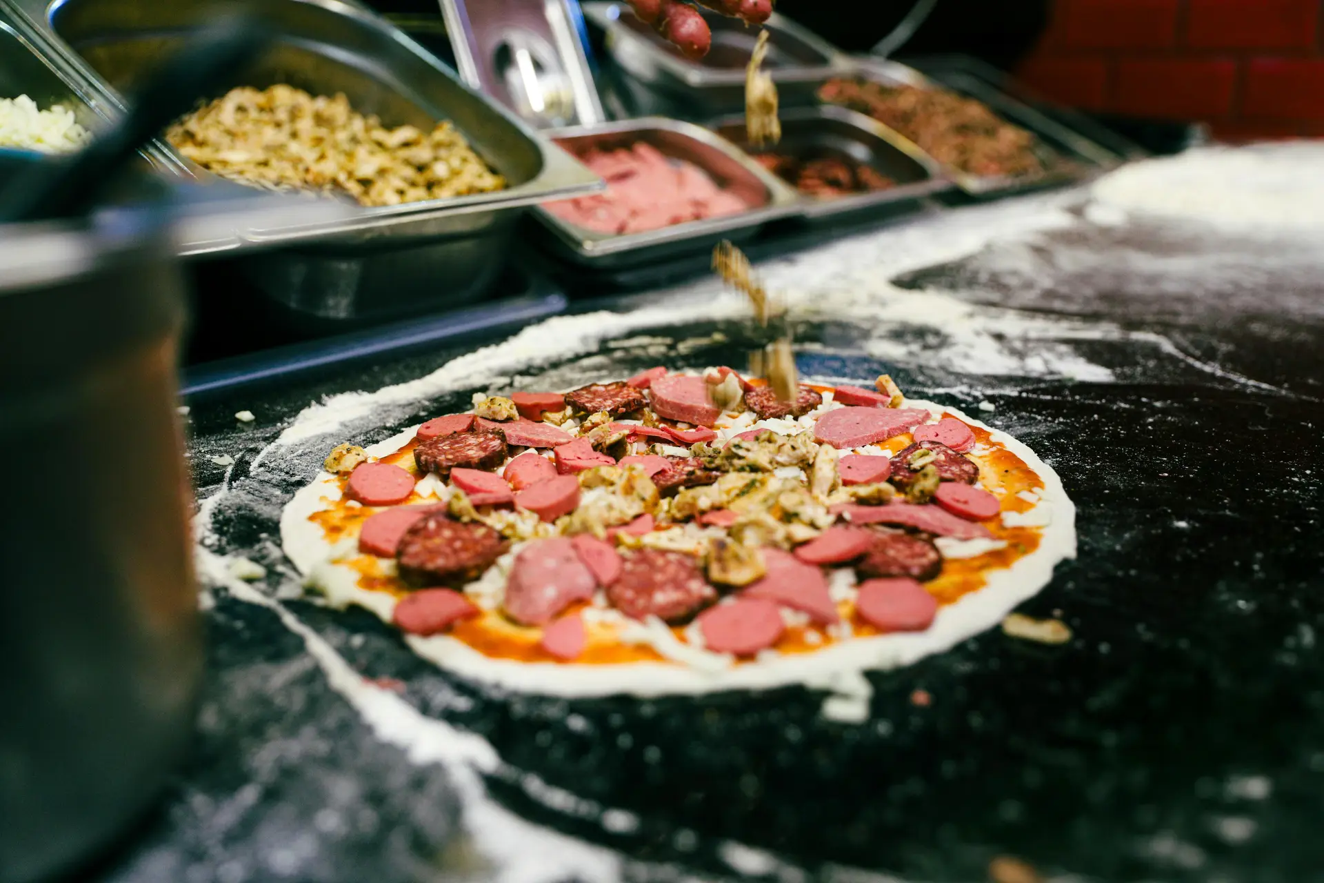 Baking a sausage pizza in the oven. It has loads of sausage as toppings.