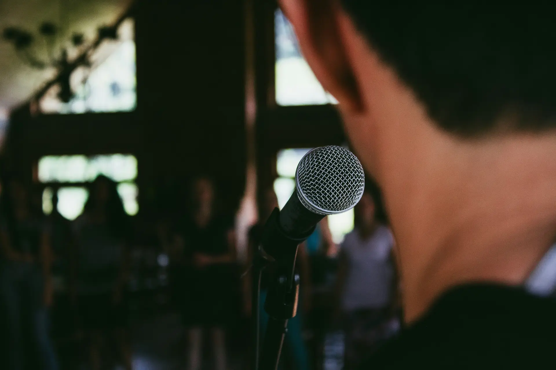 Man standing front of a microphone.