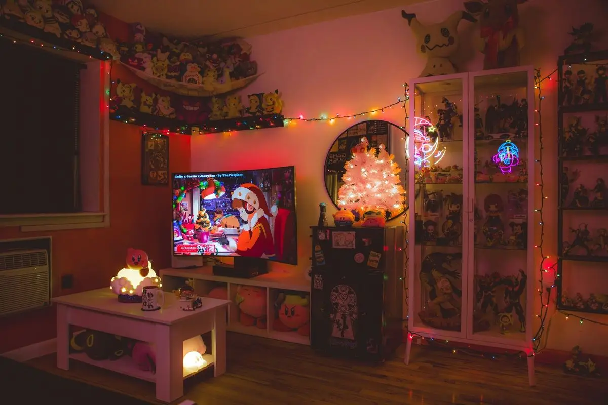 A living room decorated with christmas lights and decorations and the tv is playing music with Lofi hiphop girl..