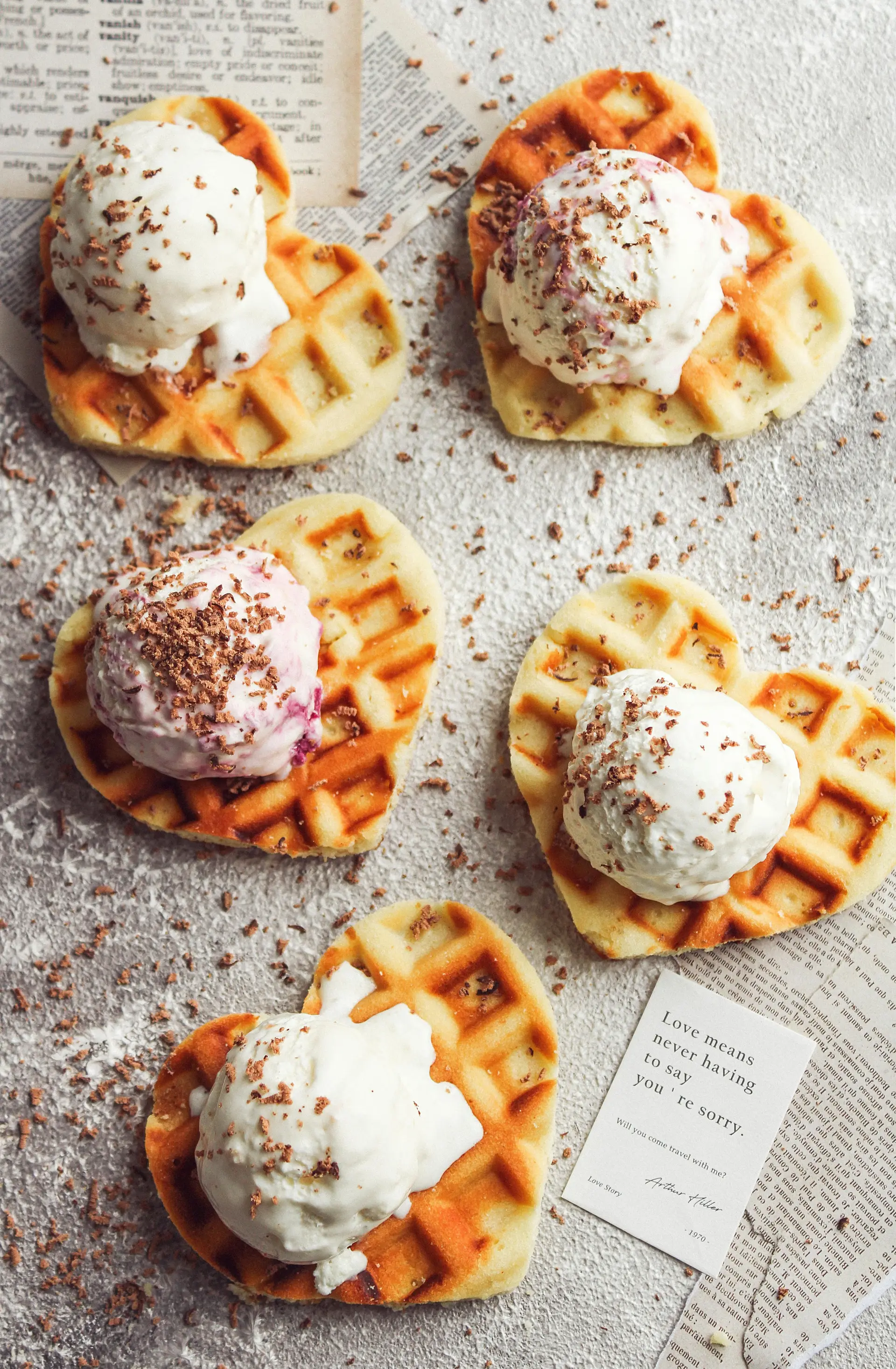 Traditional heart shaped Belgian Waffles topped with ice cream and sprinkles.
