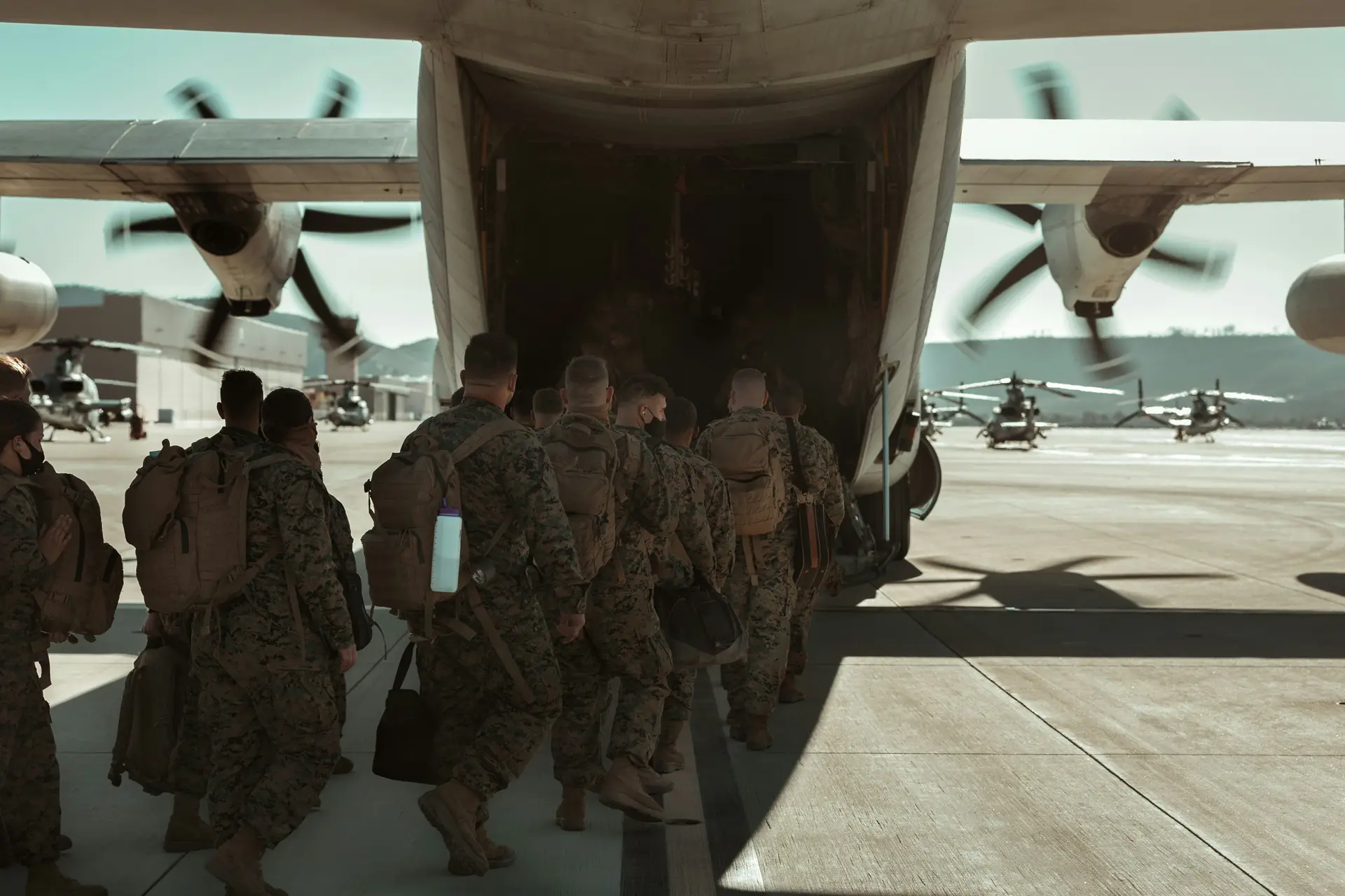 A group of airborne troops boarding a military plane.