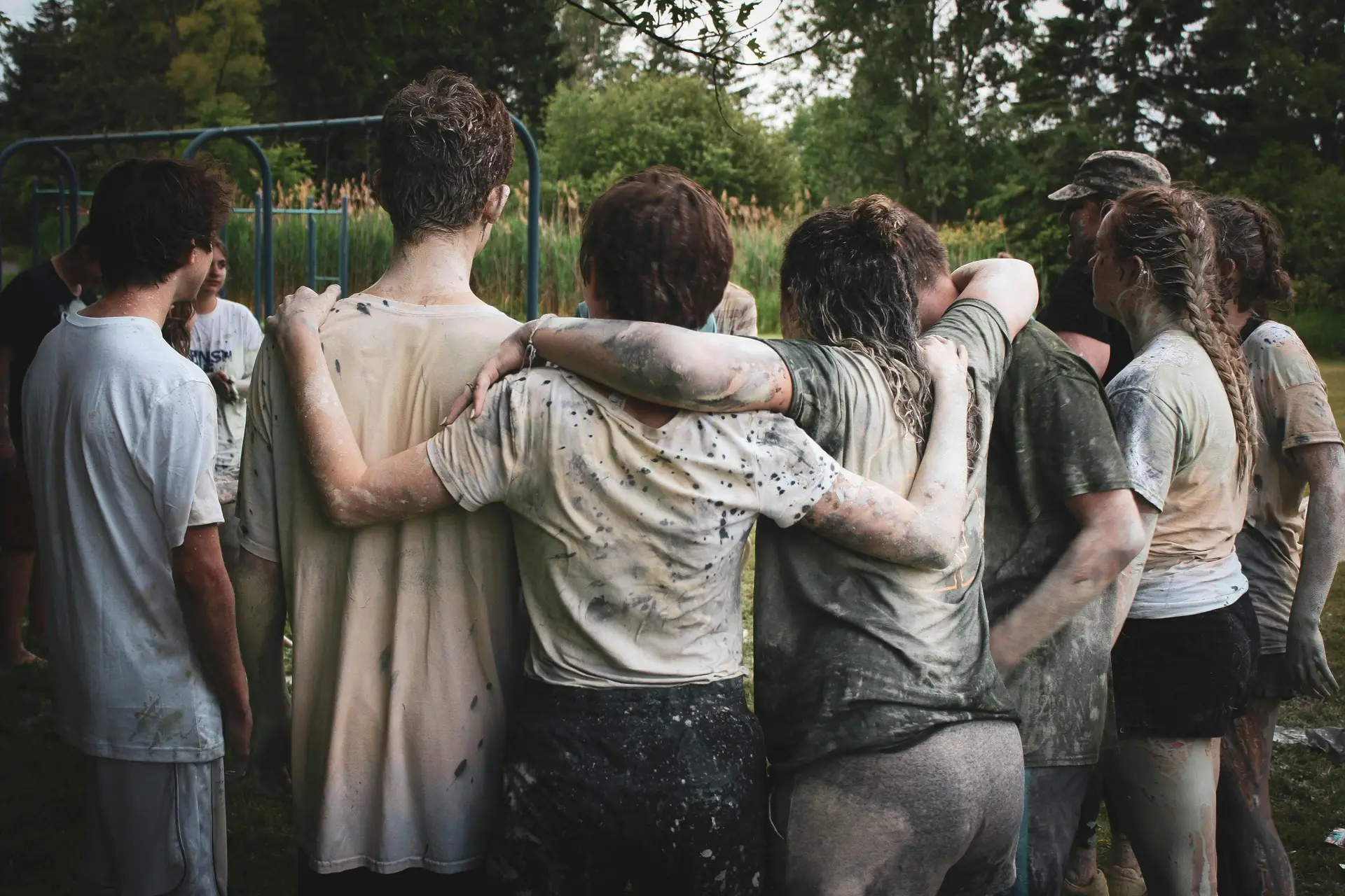 A group of youth hugging each other and forming a chain.