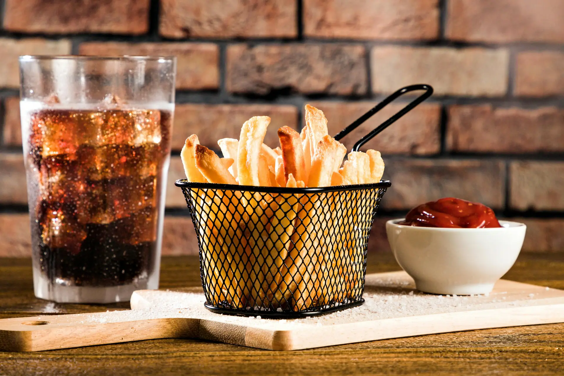 Crispy French fries served with ketchup and cold soda.