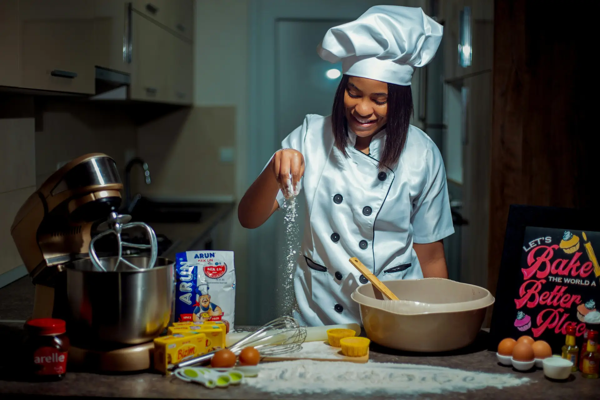 A female chef making food while laughing.