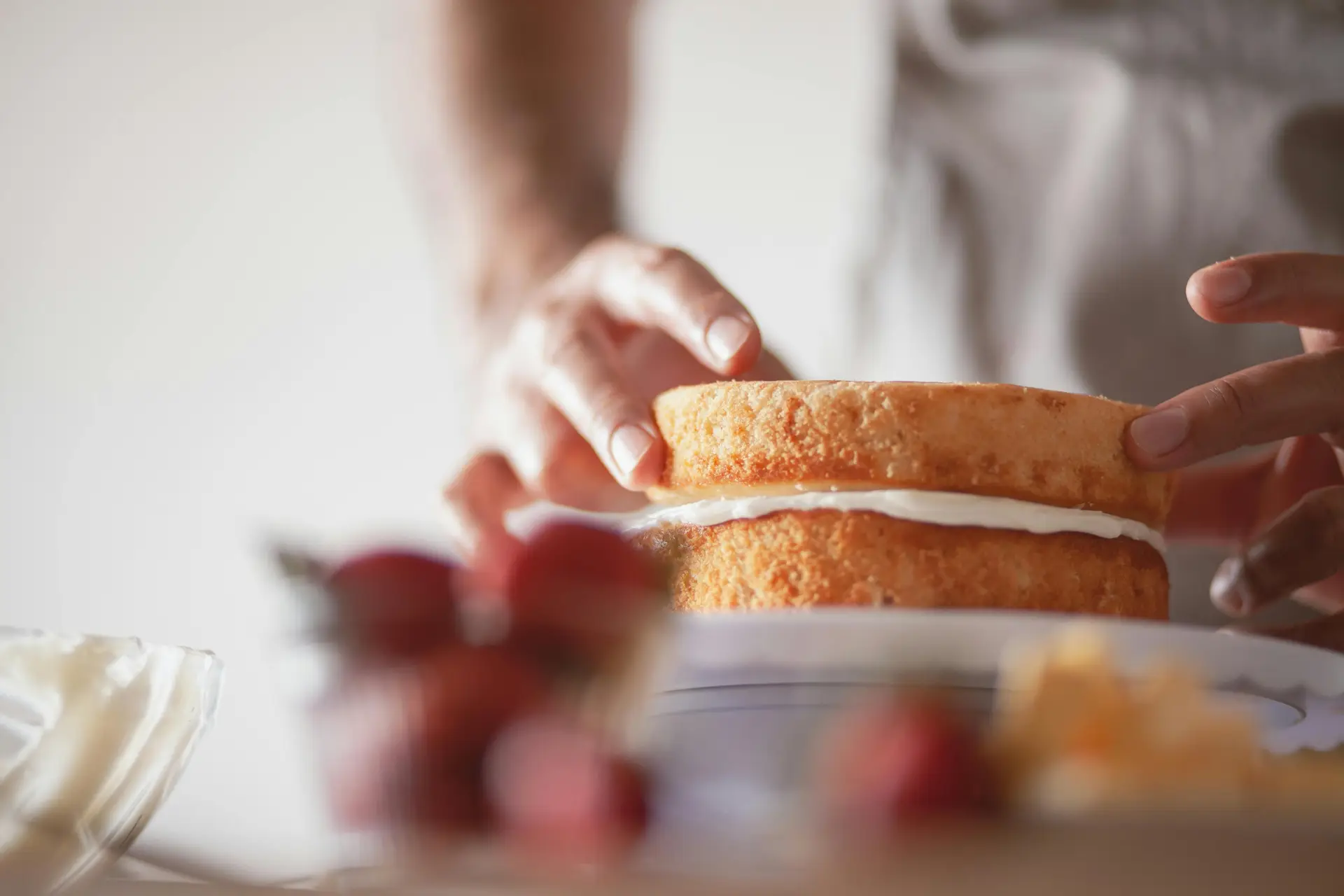 A person making a ice cream sandwich.