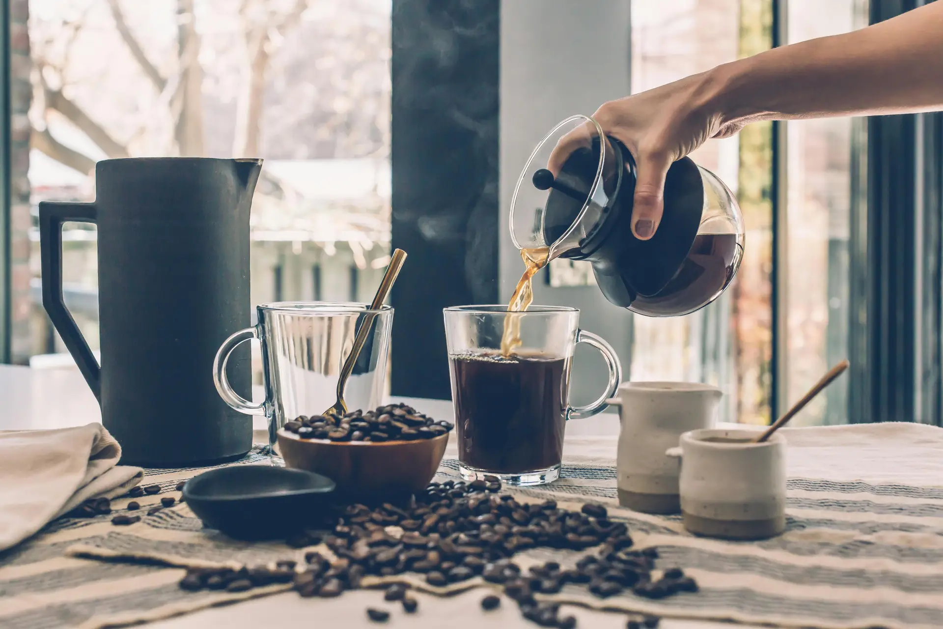 Pouring a fresh cup of coffee at home