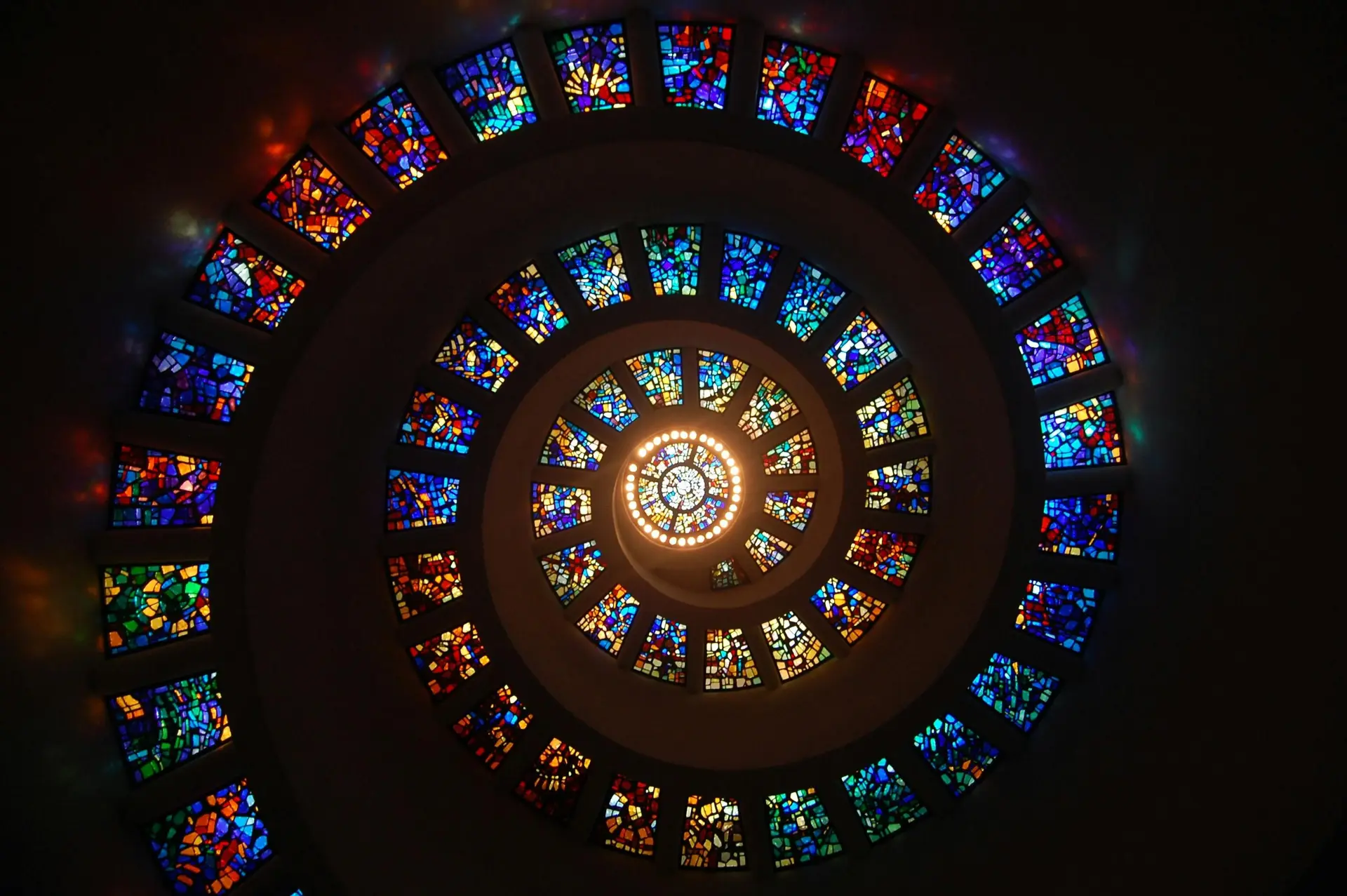 Worms Eye View of Spiral Stained Glass Decors Through the Roof.