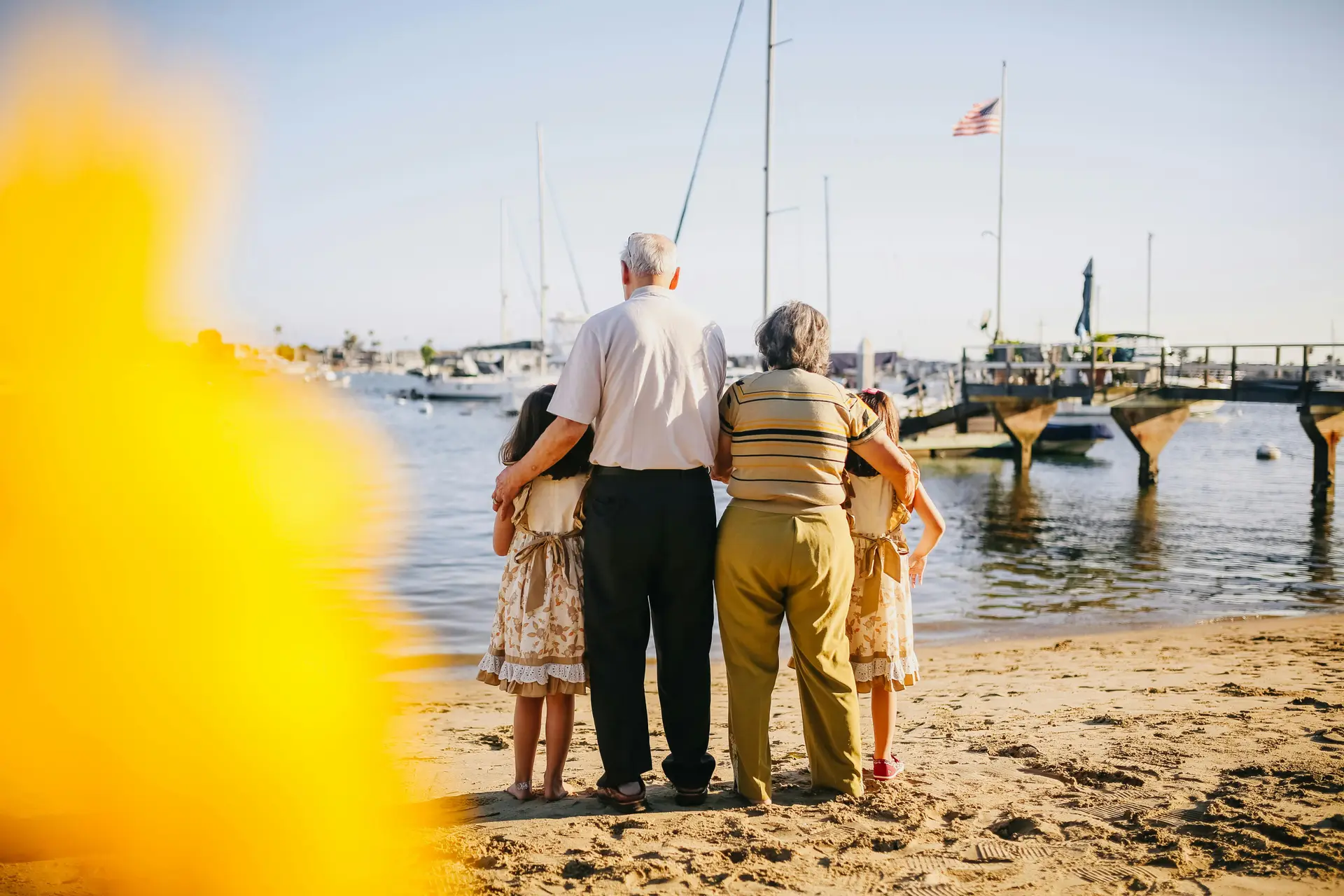Children taking photo with their grandparents near a harbor