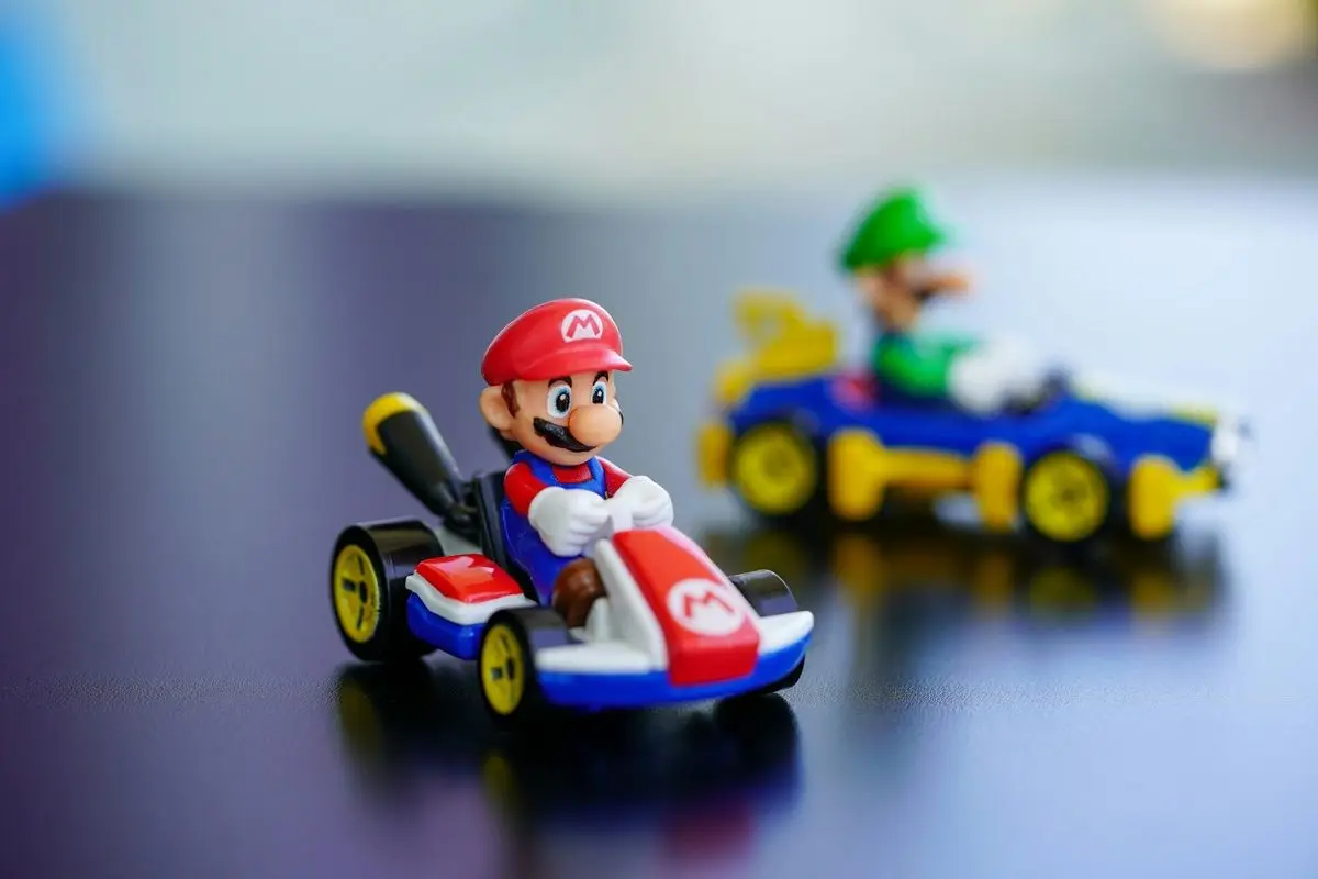 A supe rmario kart plastic figurine along with Luigi.
