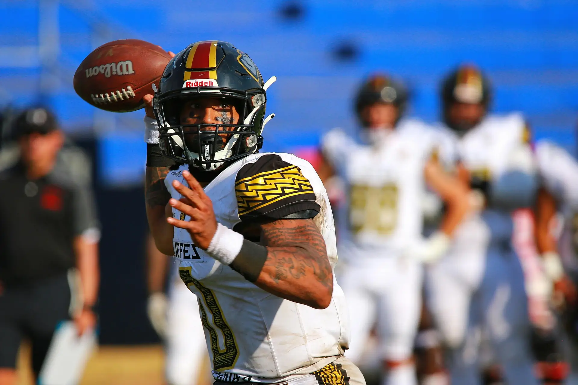 American Football player throwing the ball.