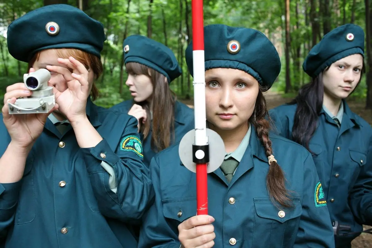 Four girl scouts in a forest.