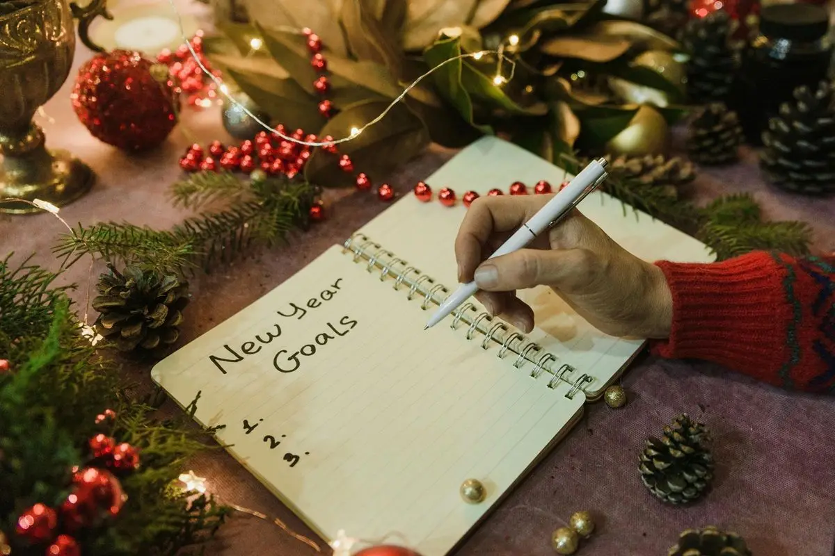 A person writing their New Year's resolutions.
