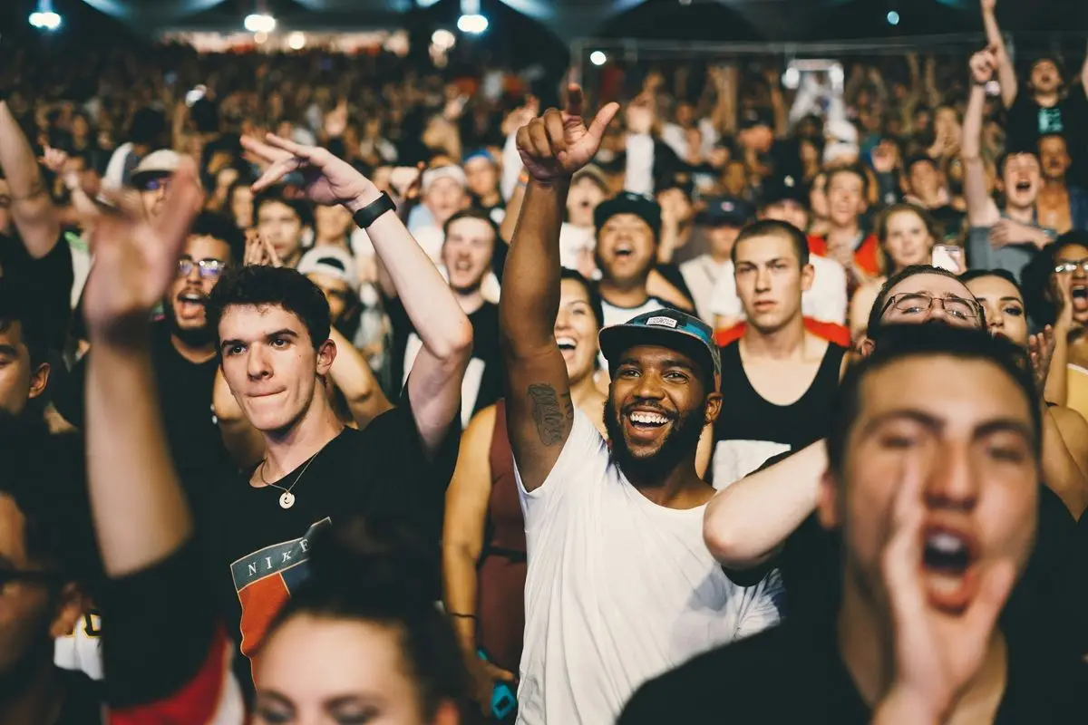 Many men cheering, celebrating.