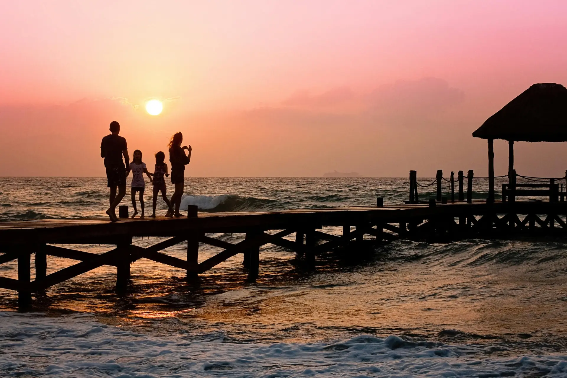 Family enjoying sunset by the sea on Family Day