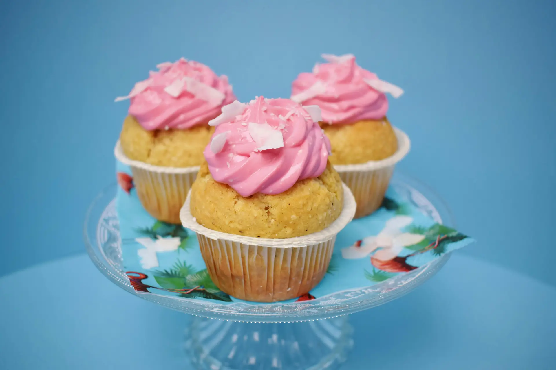 Three cup cake with icecream toppings on a glass plate.