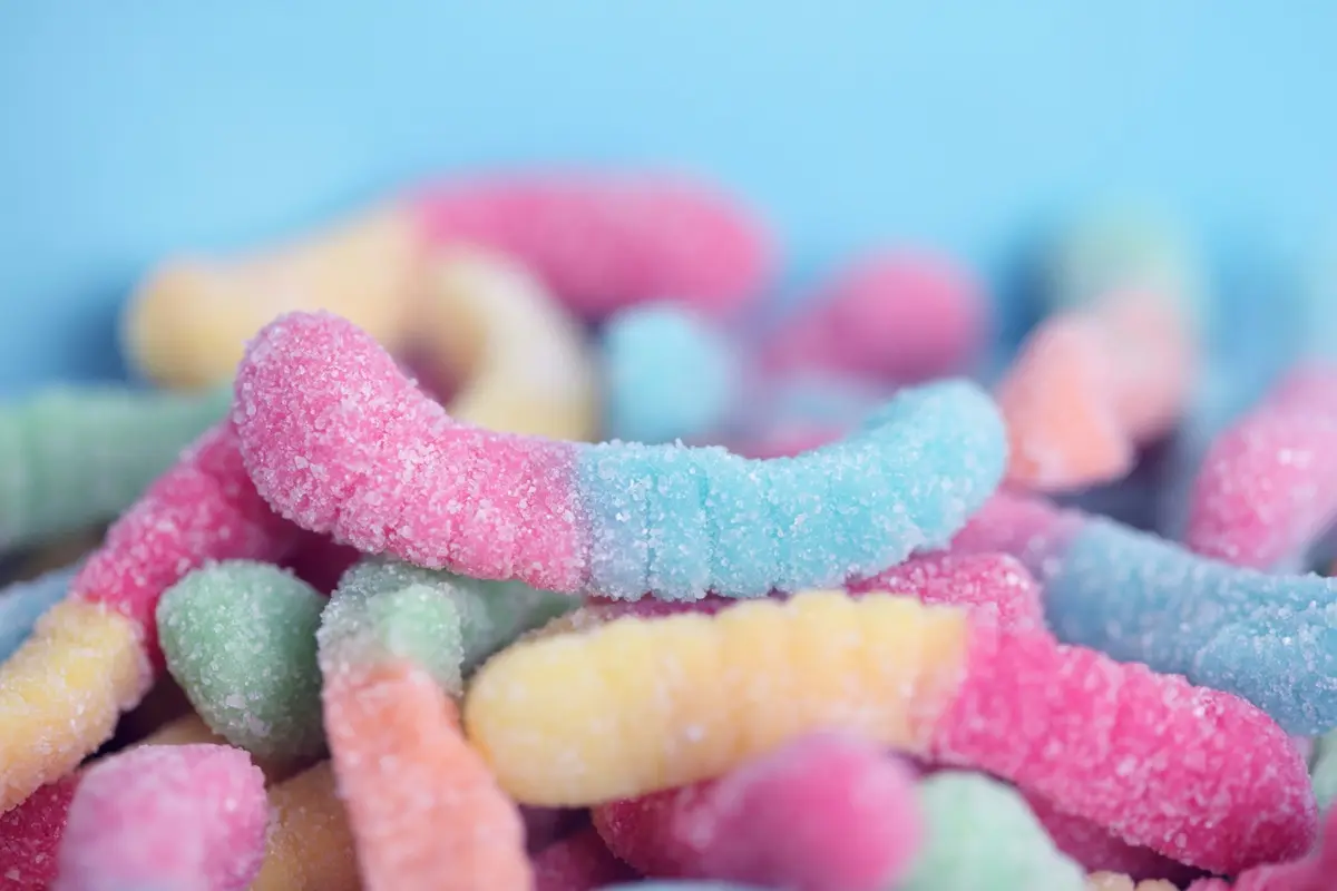 Sweet and sour gummy worms on display.