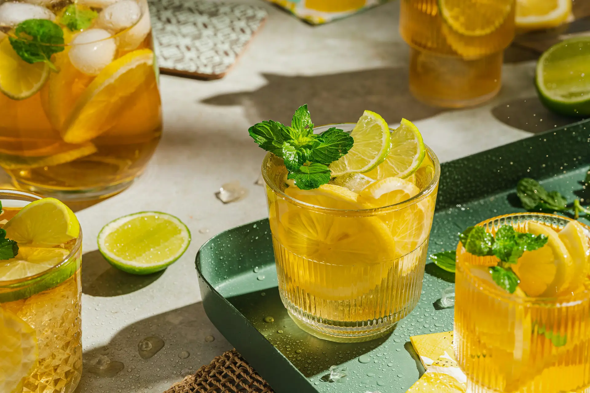 5 glasses of lemon juice along with mint leaves on a table.