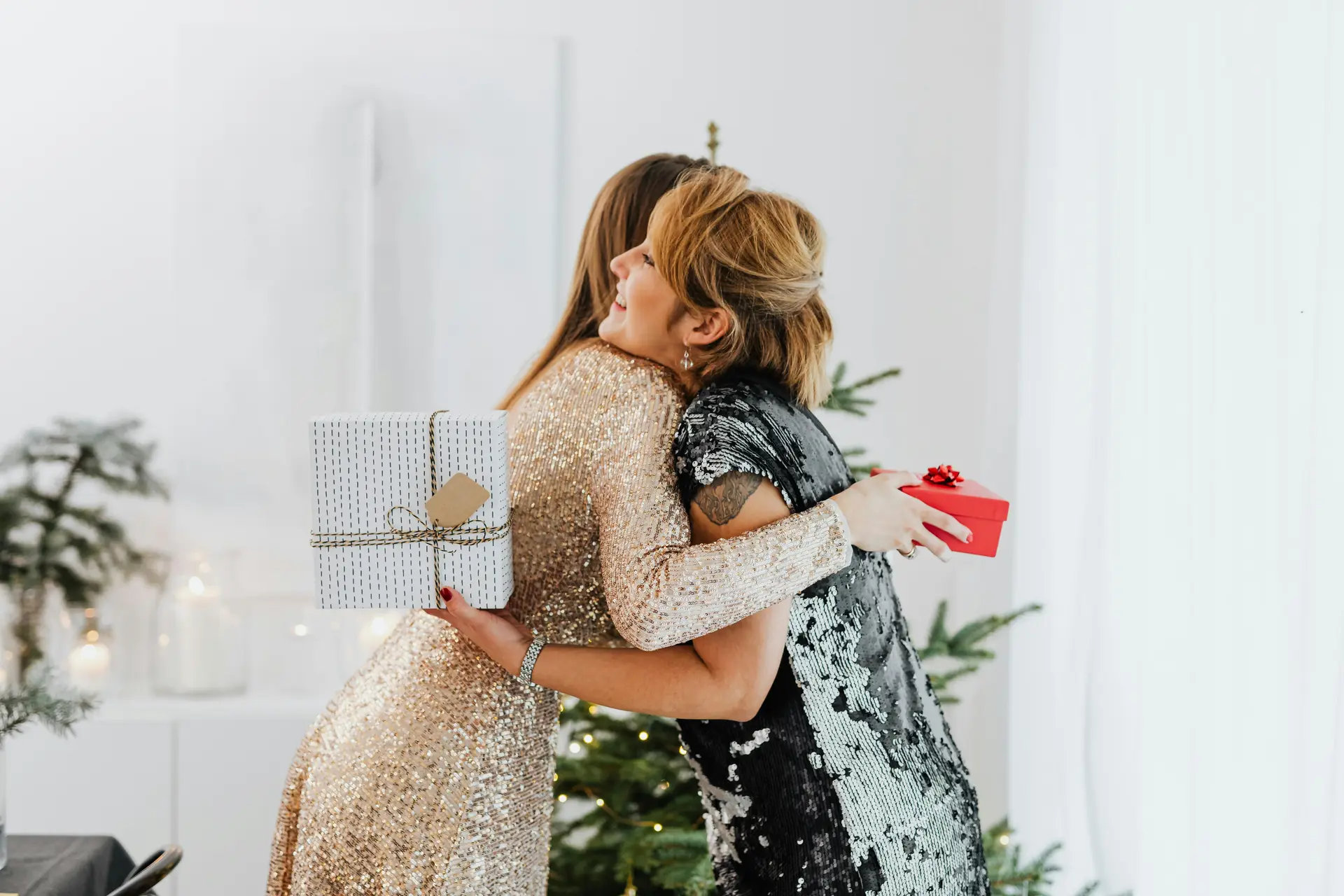 Two women hugging each other after they've had exchanged gifts.
