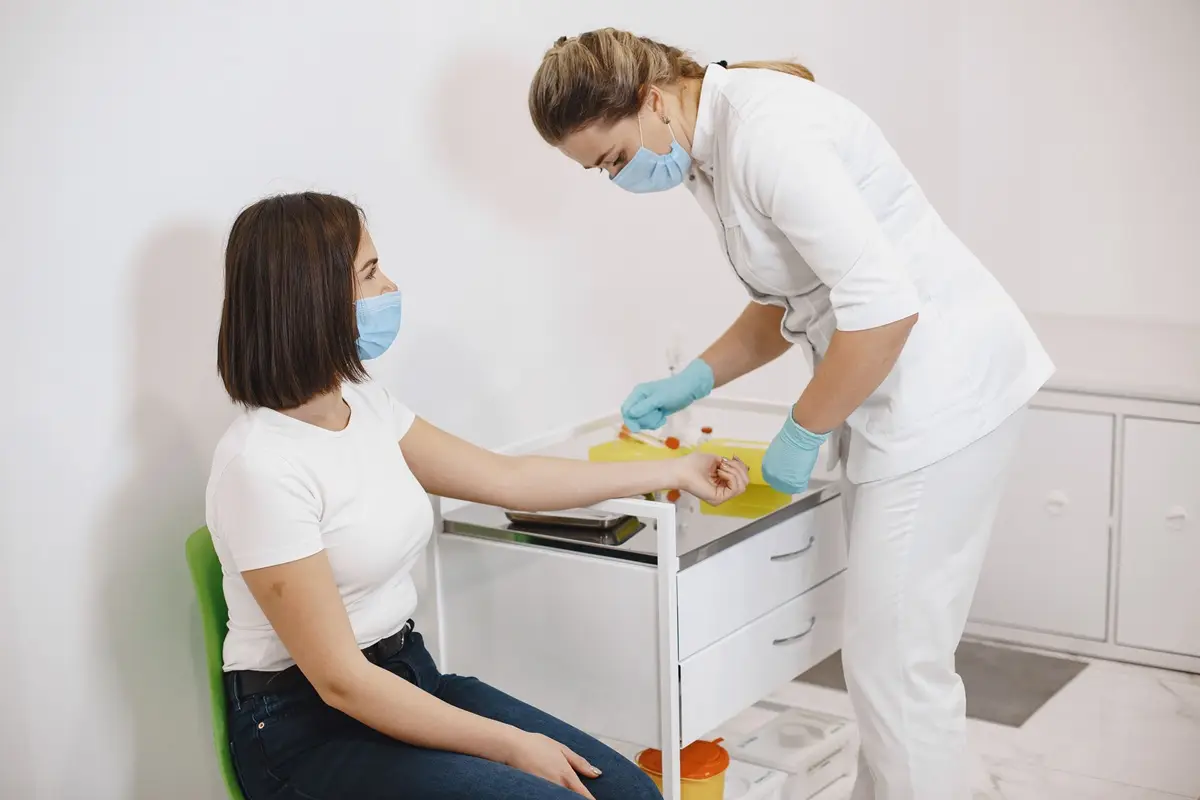 Nurse administering vaccination to patient in a healthcare setting, promoting health and safety.