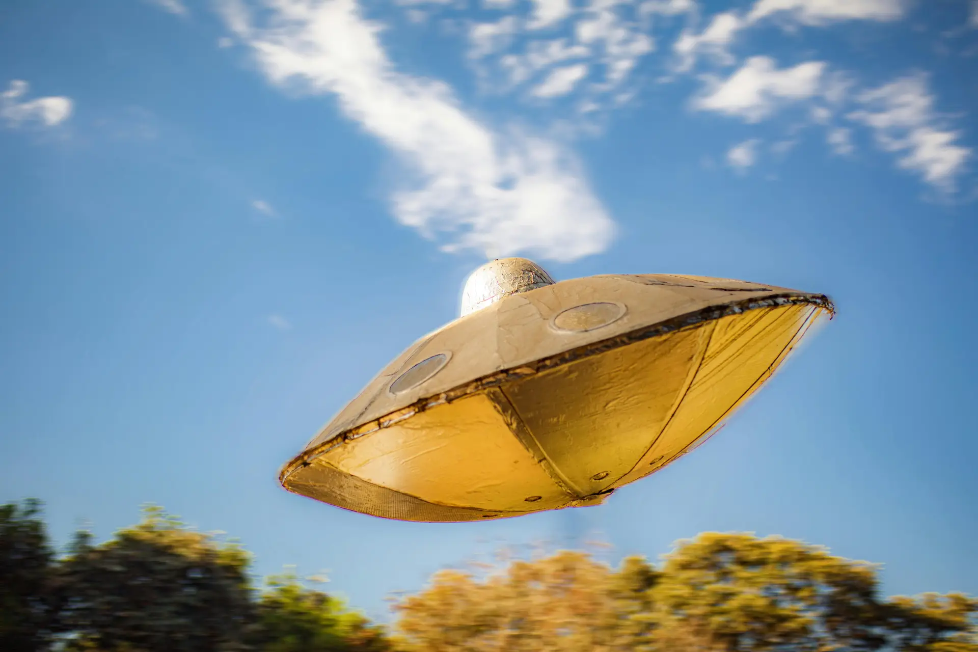 A golden color flying ufo.